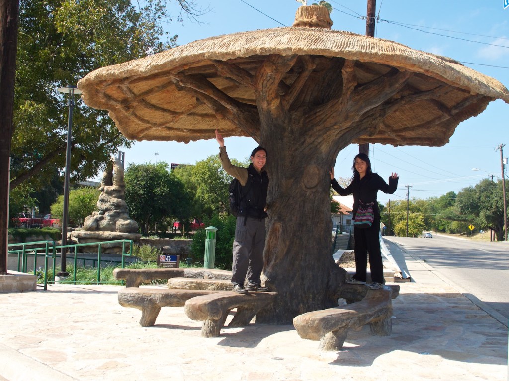 Under a Carlos Gomez sculpture along the Riverwalk in San Antonio, Texas. Our travel clothes were functional if not stylish.