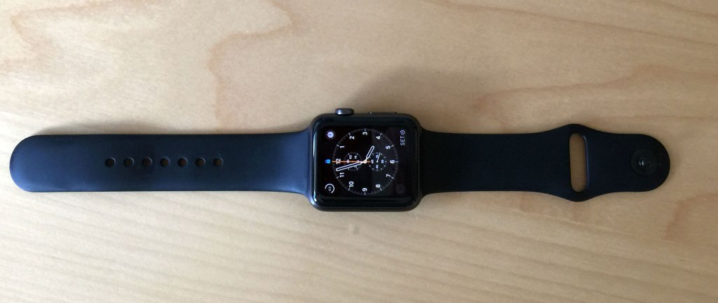 I find it easier to put on when I placed the band with the loop closure on the bottom rather than the top.